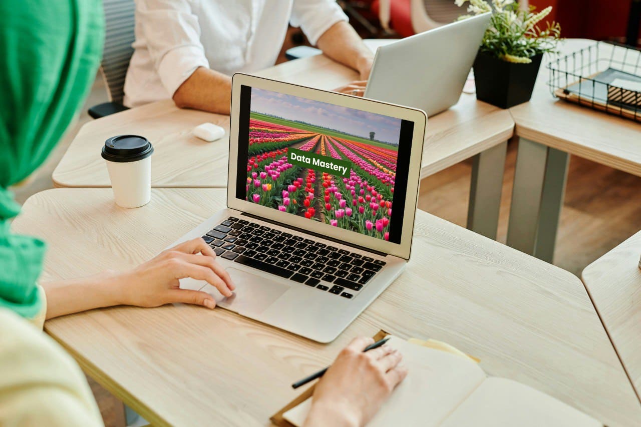 Person using a laptop with a screen displaying 'Data Mastery' C++ course in a casual office setting
